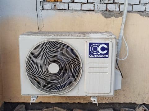 Wall-mounted air conditioner unit outside a building